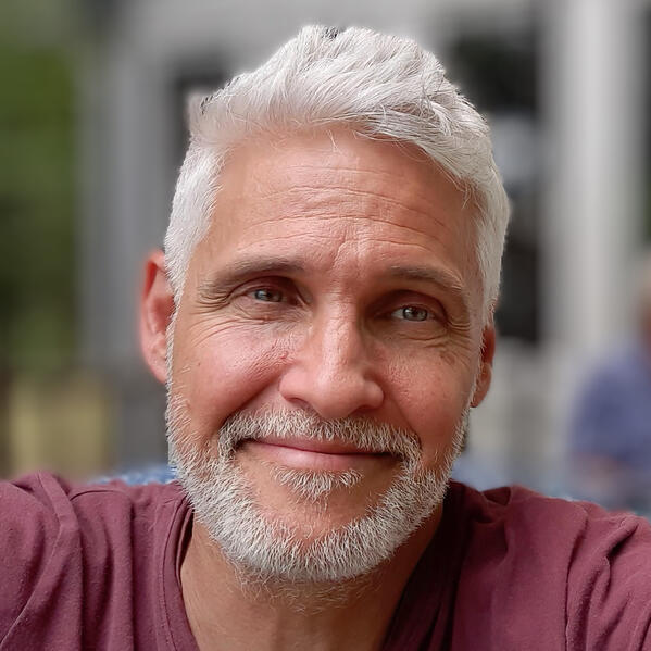 Photo of Mike Laroque, founder of Solarama.org, with red shirt and white hair